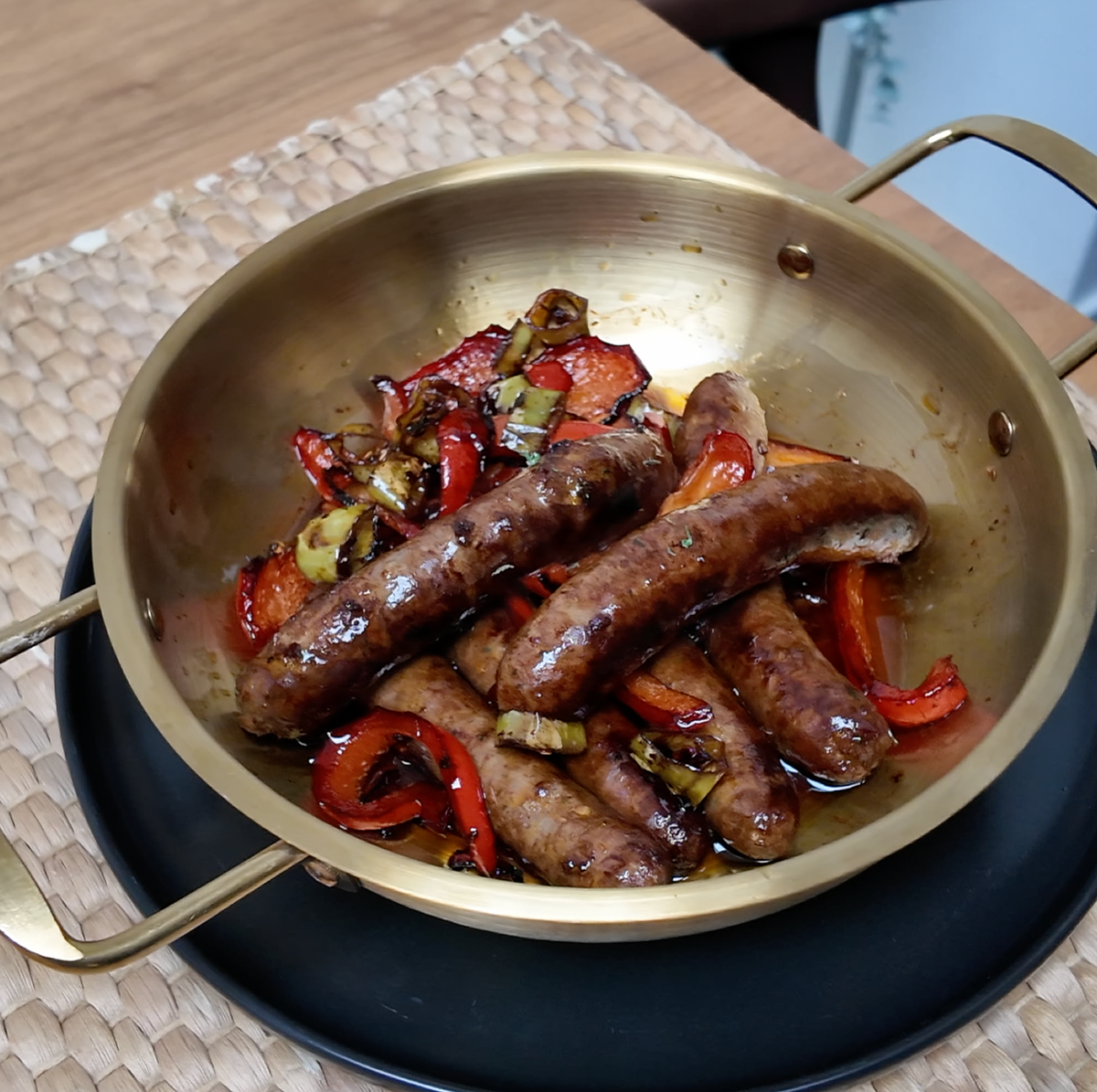 Sausages Pack: sausages and peppers cooking in a brass pan