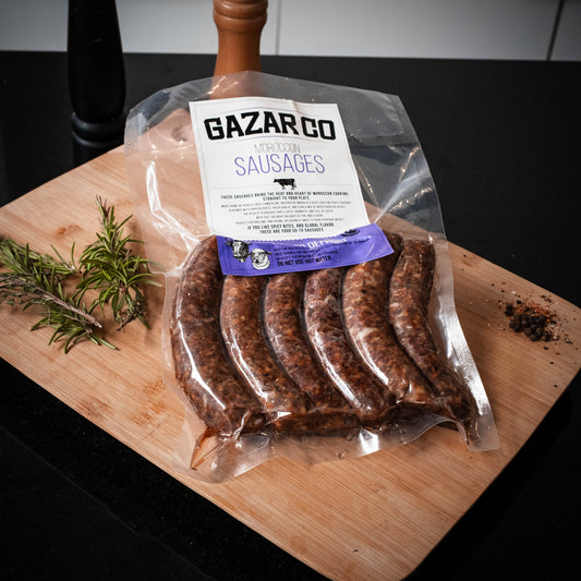 Sausages Pack: Gazar Co pack of sausages on a wooden board with rosemary